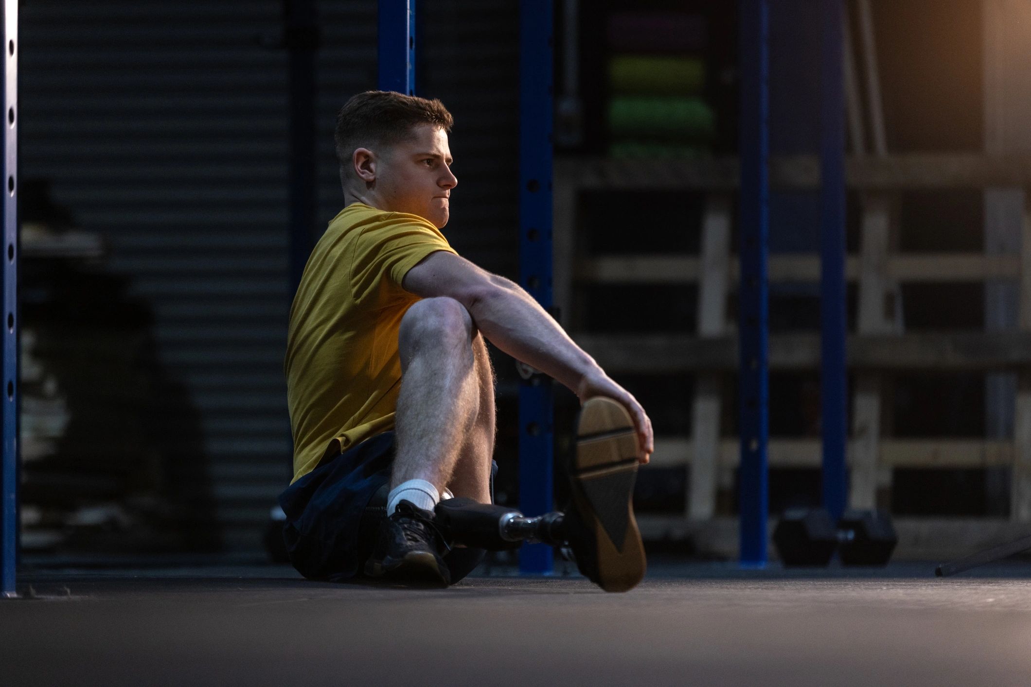Athlete stretching on a gym floor
